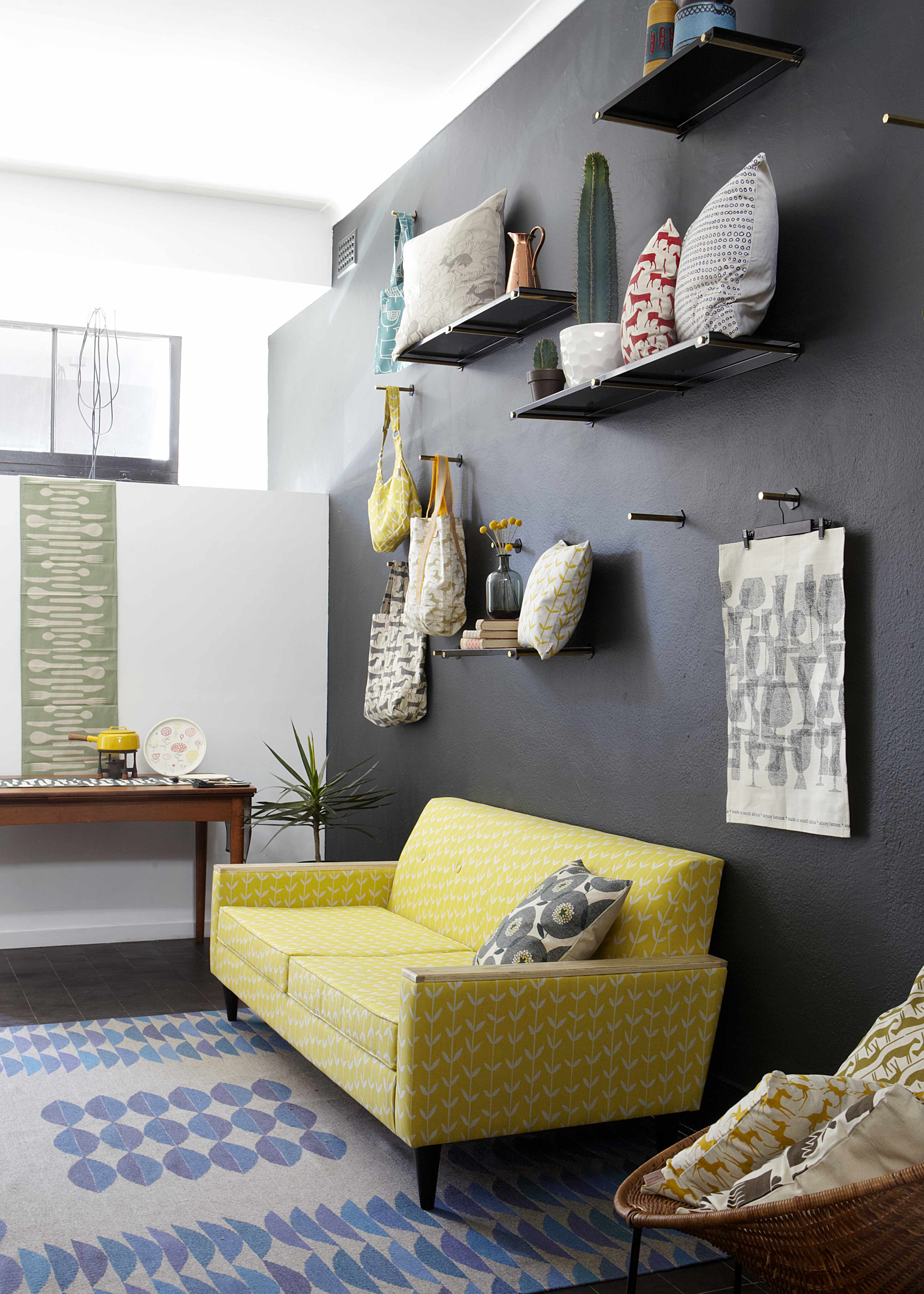 Yello and Grey Sofa with Black Wall