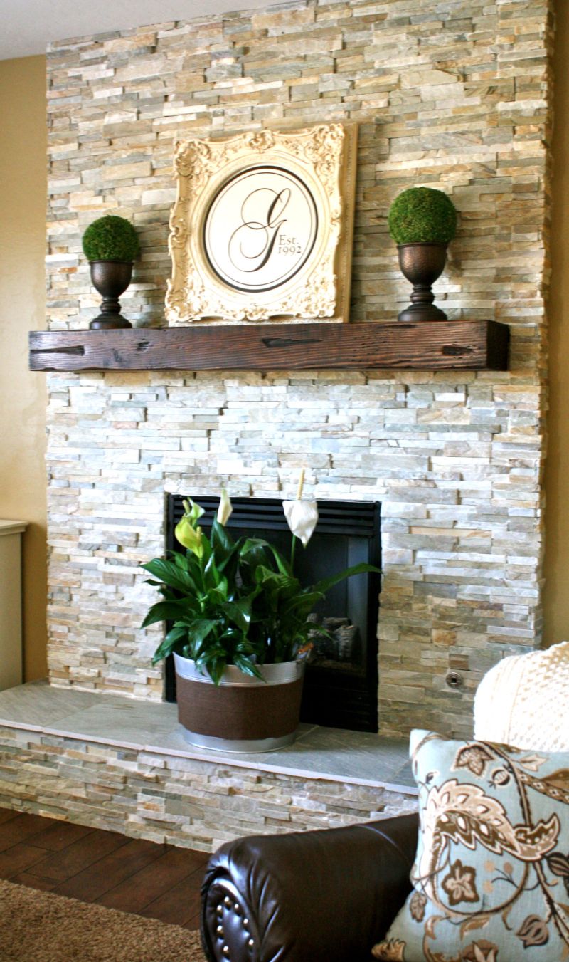 Stacked white fireplace stone with wood log
