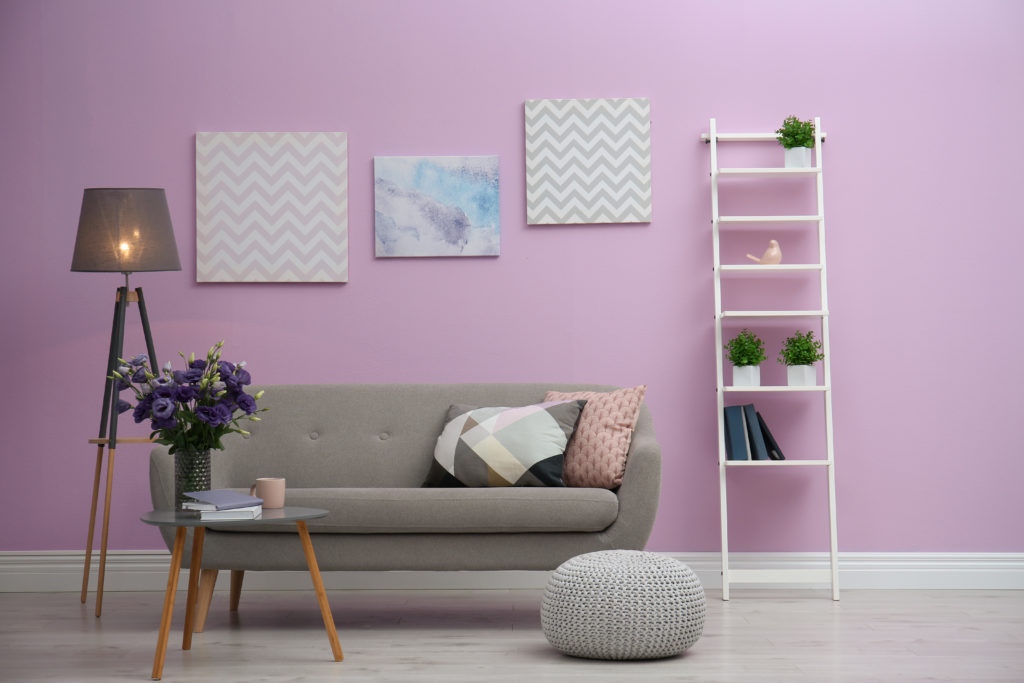 Modern living room with gray couch and lilac walls